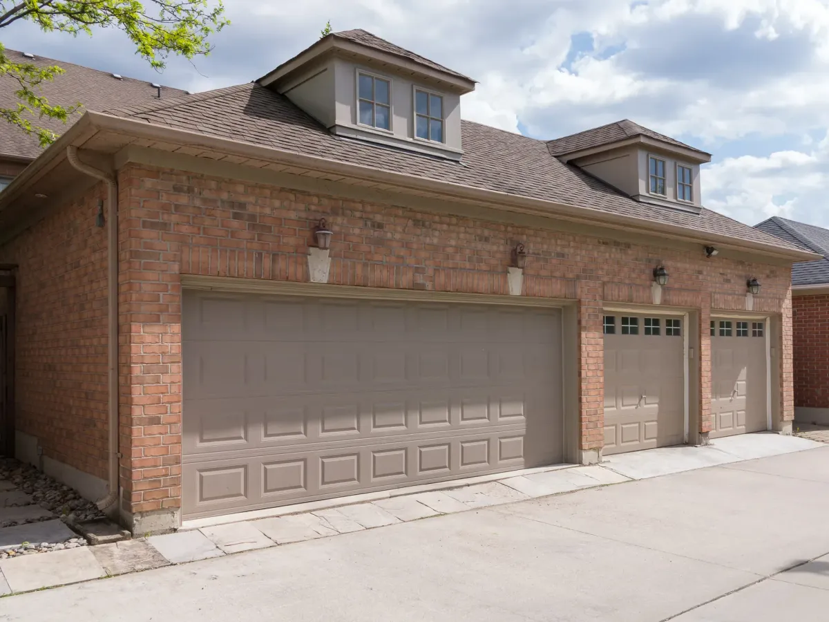 Suburban home exterior with a two-car garage door and driveway