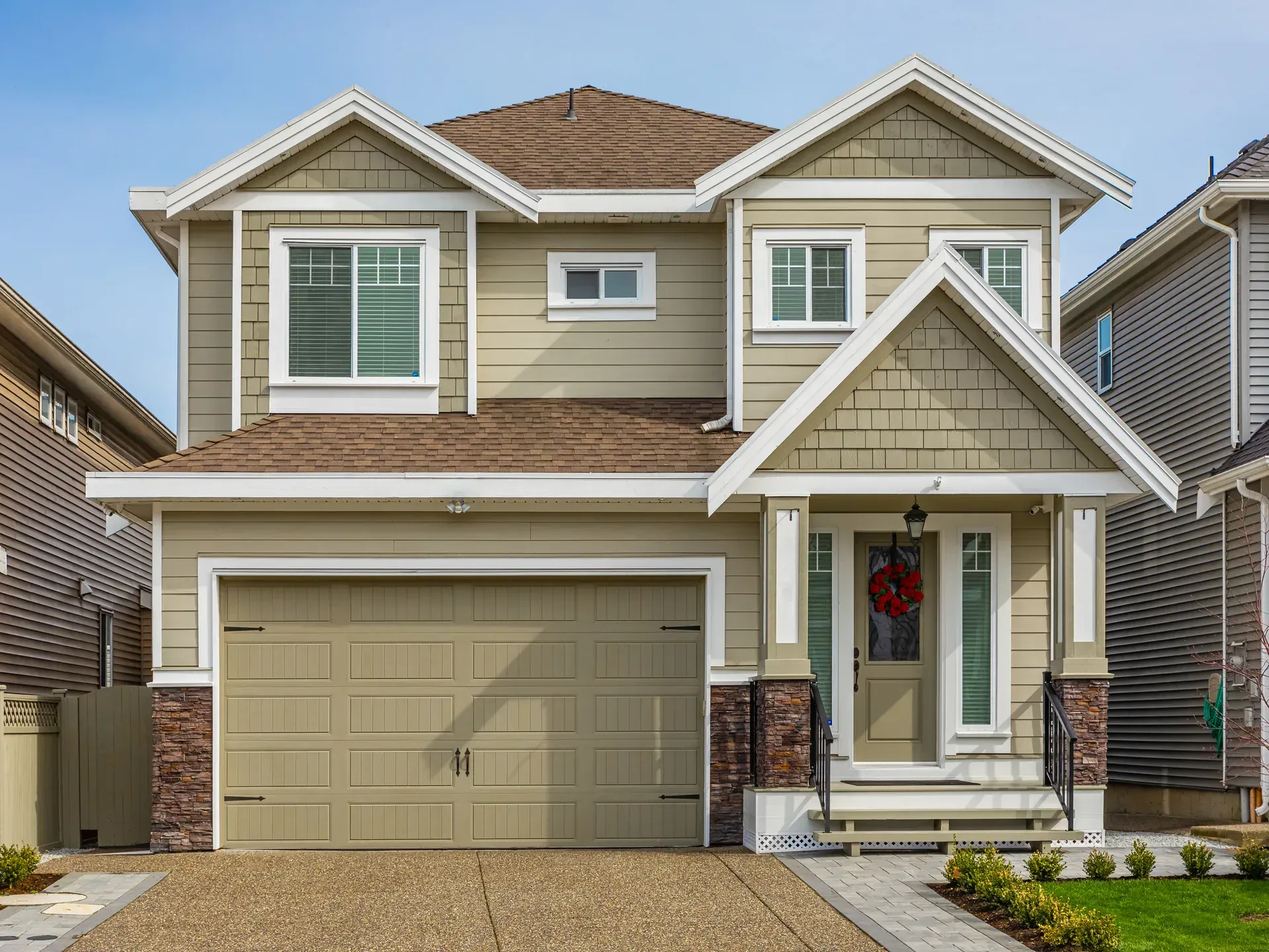 Garage door installer using tools near a residential garage door