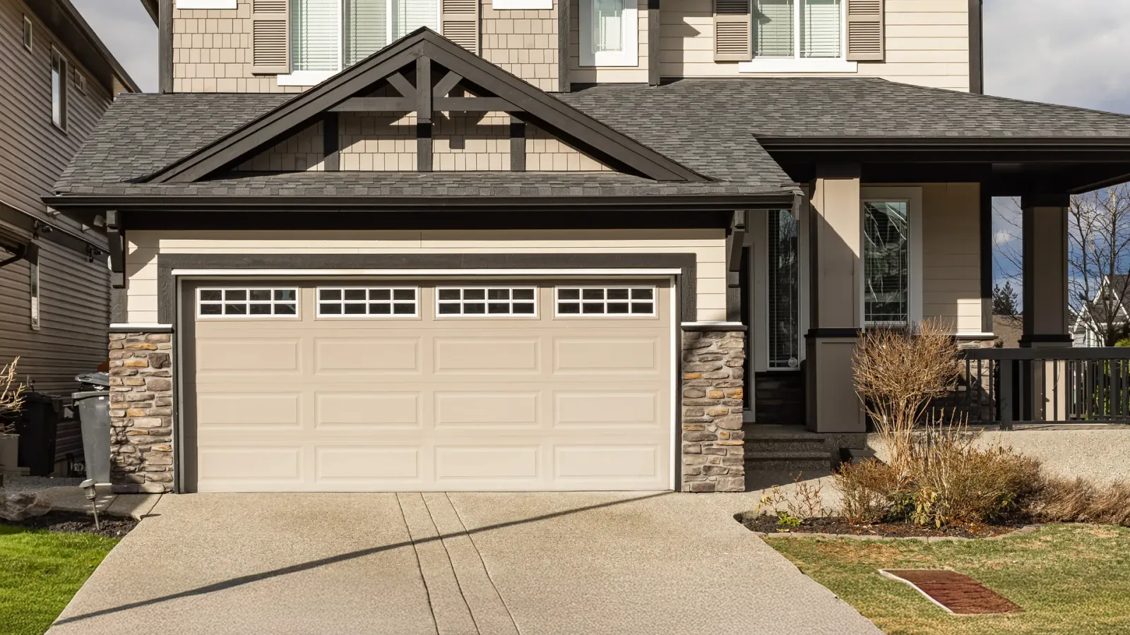 Home exterior with a prominent garage door and driveway
