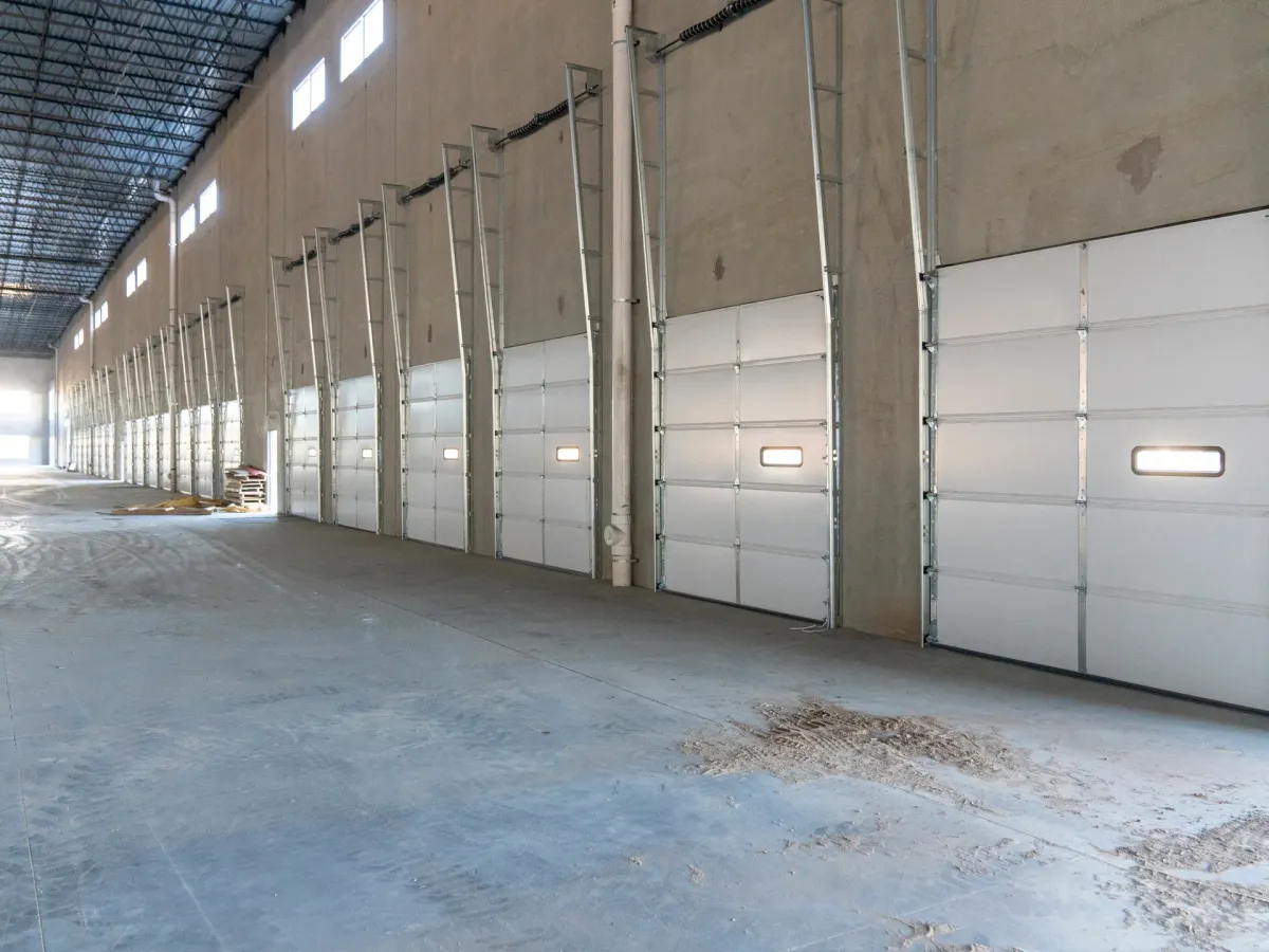 Garage interior with an overhead door and clean concrete floor