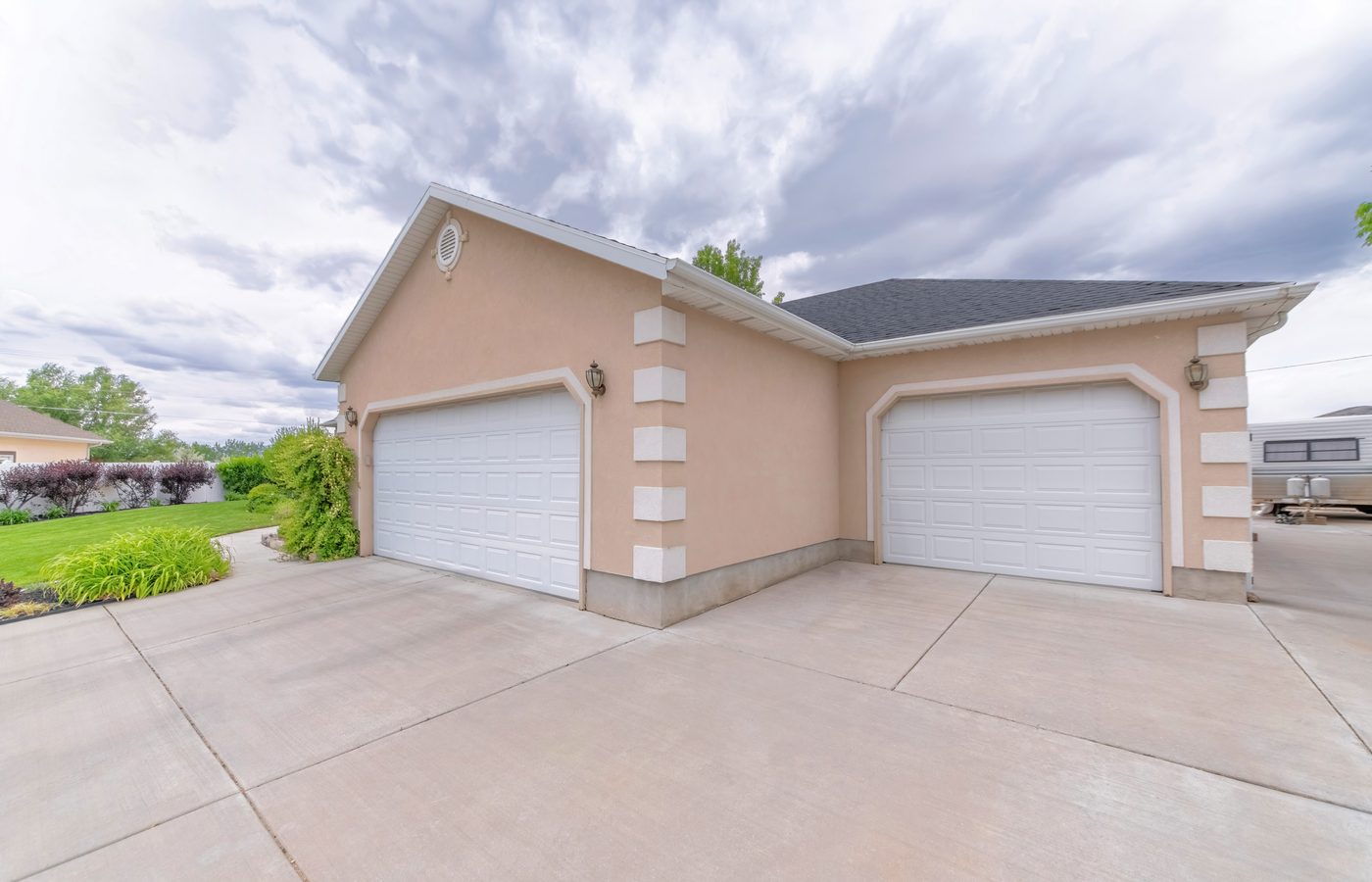 Wood-grain carriage garage doors installed on a craftsman home